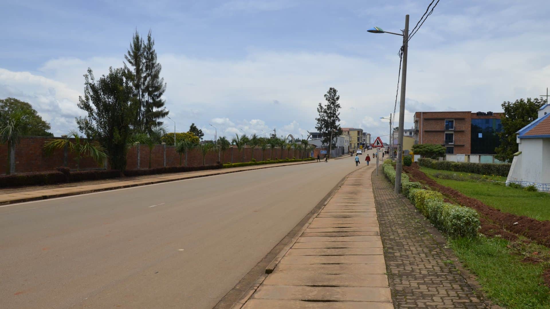 A clean, tree-lined Kigali street